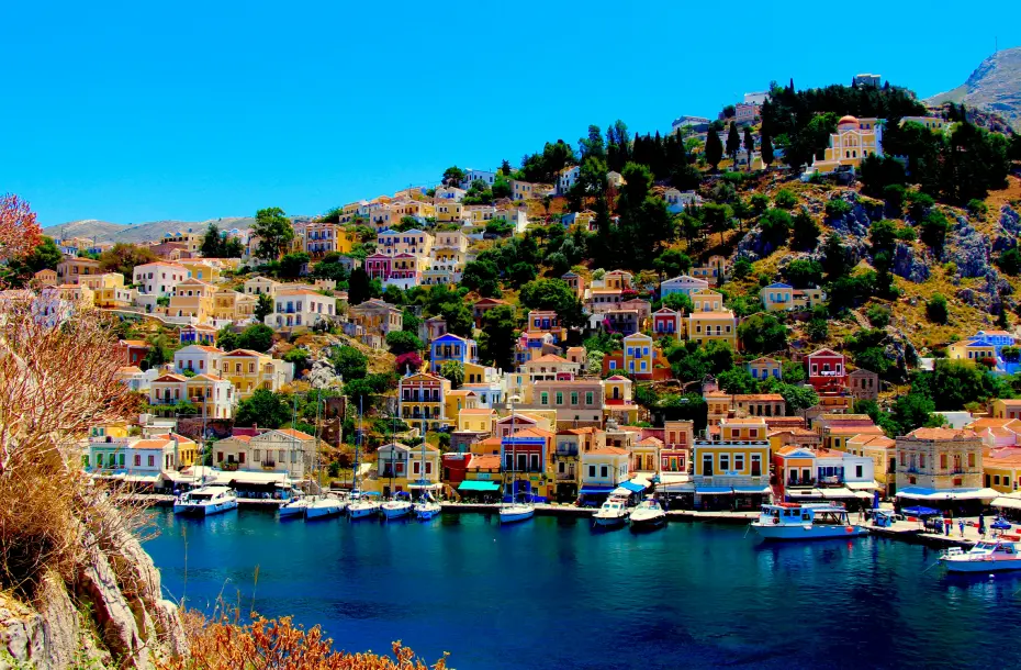 The port of Chalki with traditional fishing boats and colorful houses around