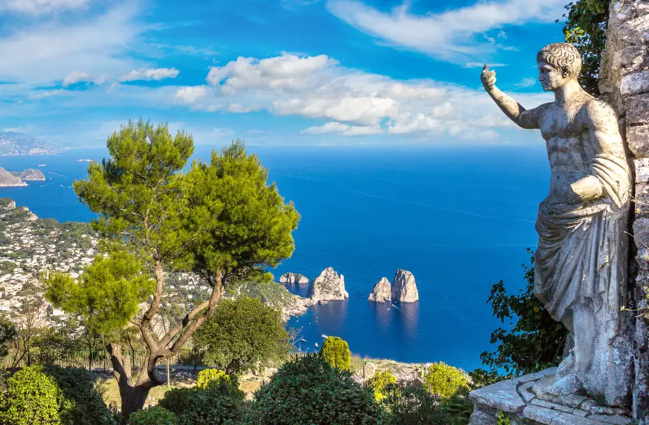 The statue of Emperor Augustus on a hill in Capri, overlooking the blue sea and the "Grottoes"