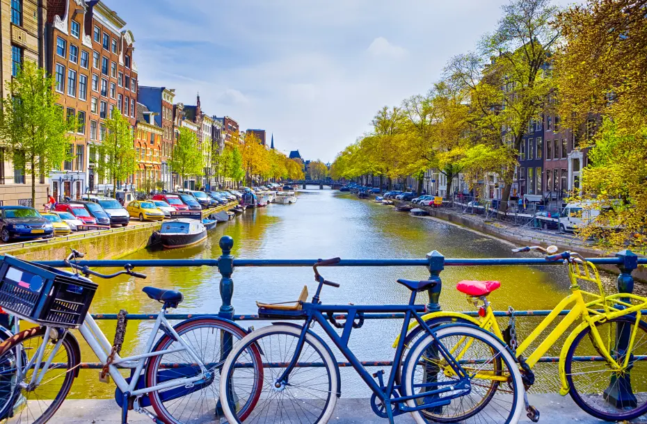 Colorful parked bikes on the bridge above Amsterdam's famous canal