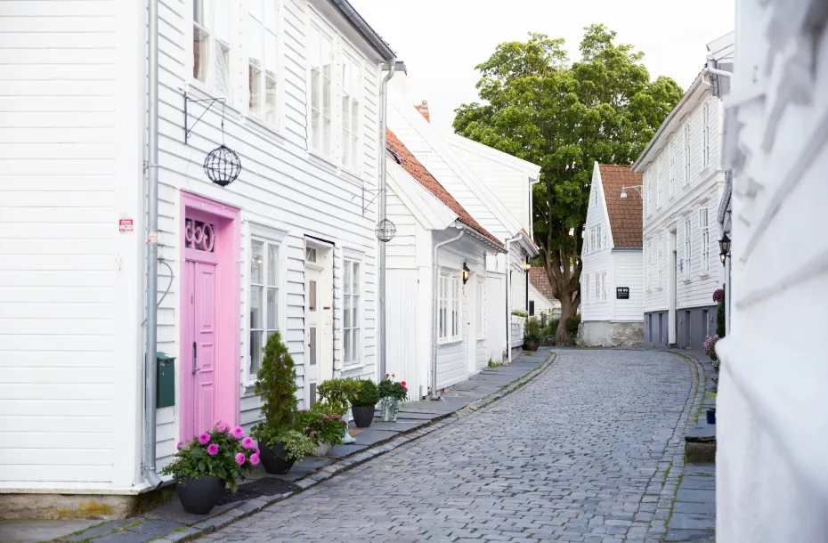 Paved road in Stavanger. Elegant white buildings on both sides