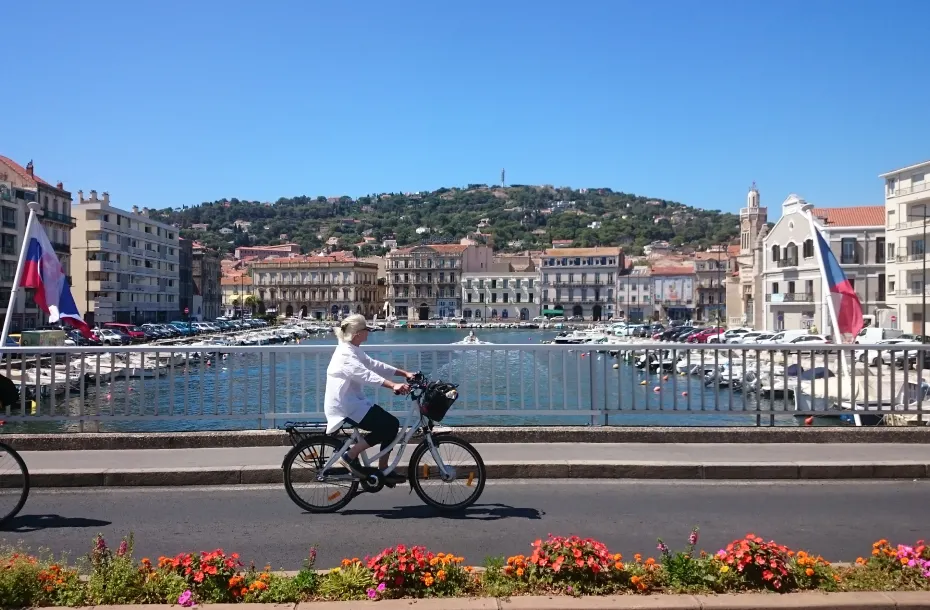 Woman riding her bike through Sete, France