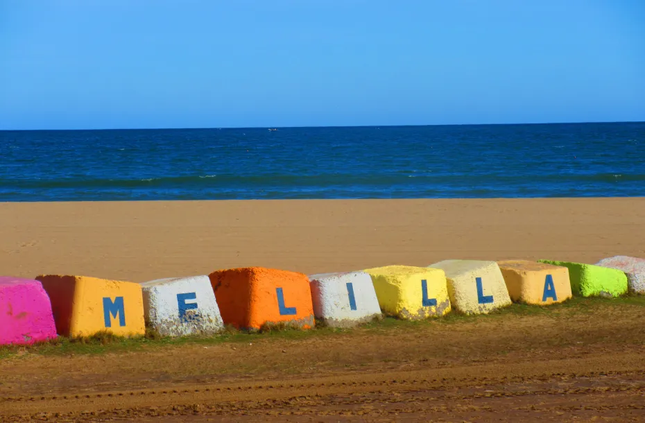 Multicolored stones on the beach that write the name of Melilla